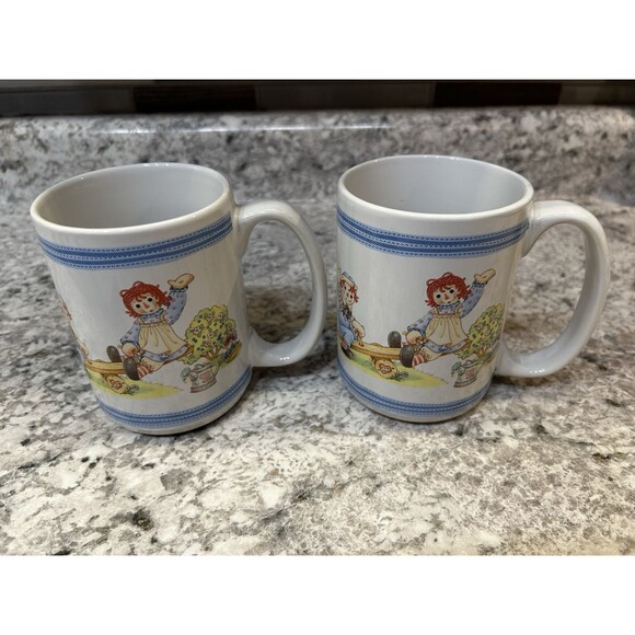 Raggedy Ann and Andy Waving Houston Harvest Cup Mug Coffee Tea Set of 2 - Picture 1 of 5
